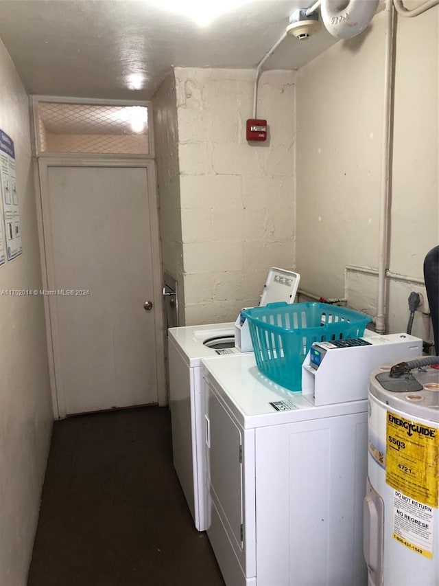 clothes washing area with independent washer and dryer and electric water heater