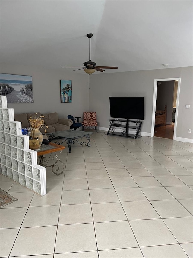 unfurnished living room featuring ceiling fan and light tile patterned flooring