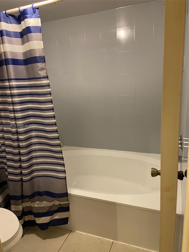 bathroom featuring tile patterned floors, shower / bath combo, and toilet