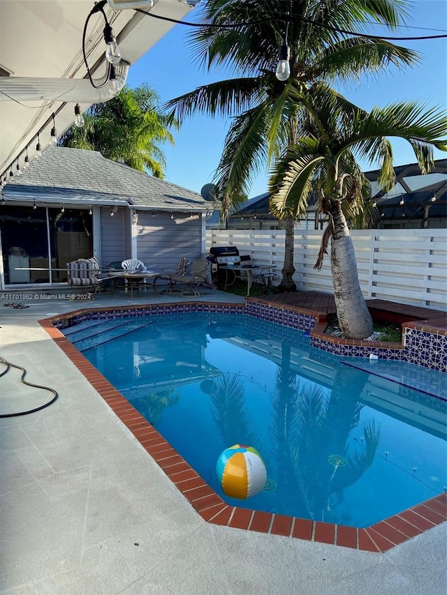 view of swimming pool with a patio