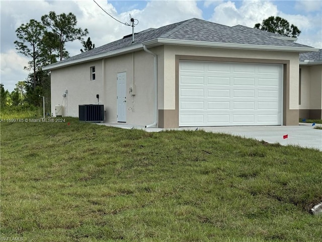 view of front facade featuring central AC unit, a garage, and a front yard