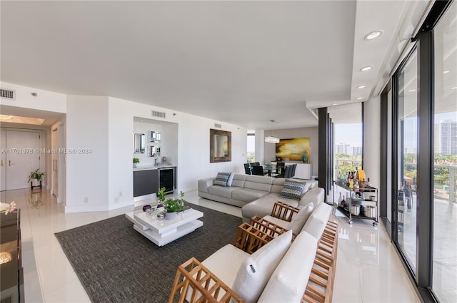 living room with floor to ceiling windows, beverage cooler, and light tile patterned flooring