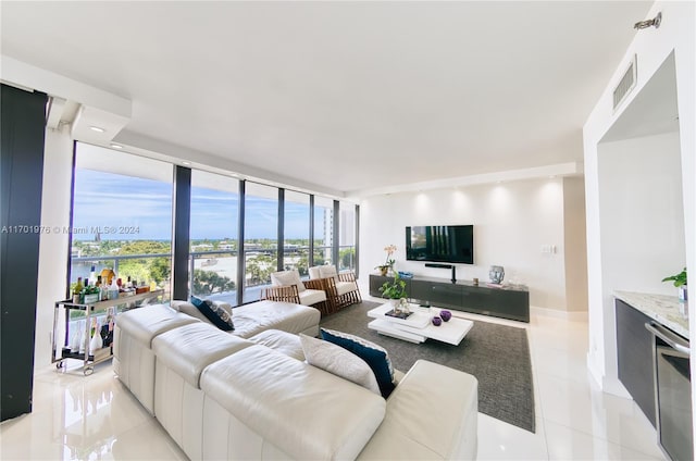 living room featuring expansive windows and light tile patterned floors