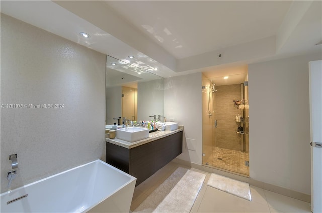 bathroom with tile patterned flooring, vanity, and separate shower and tub