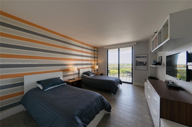 bedroom featuring access to exterior and dark hardwood / wood-style flooring