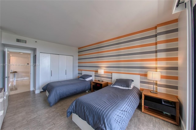 bedroom with a closet and light wood-type flooring