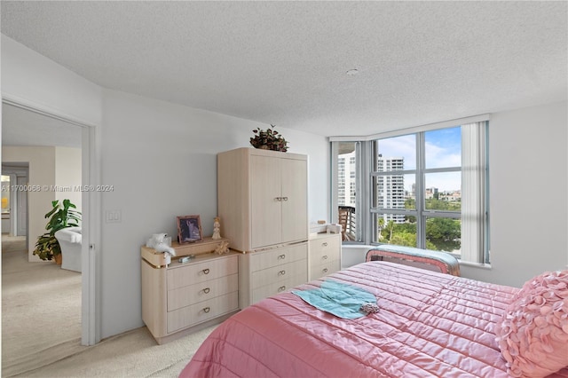 carpeted bedroom featuring a textured ceiling