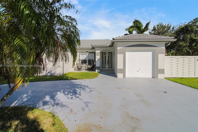 mediterranean / spanish-style house featuring a garage and french doors