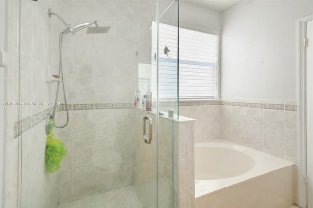 bathroom featuring independent shower and bath