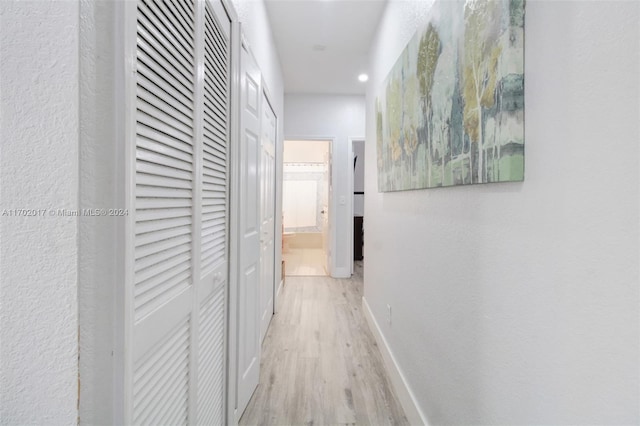 corridor with light hardwood / wood-style floors