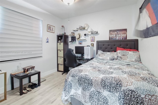 bedroom featuring ceiling fan and light wood-type flooring