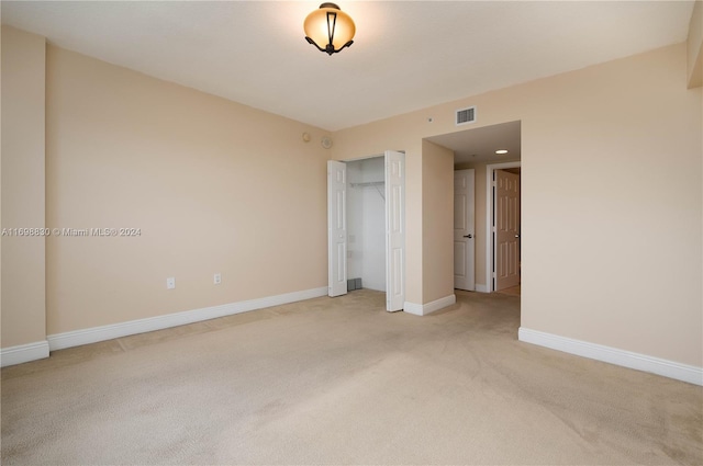 3232 SW 22nd Ter Unit 1504, Miami, FL 33145 - unfurnished bedroom with light carpet, baseboards, and a closet