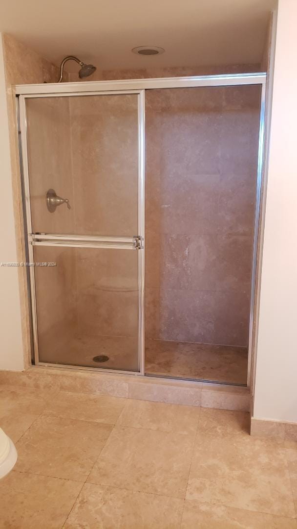 bathroom with a shower with door