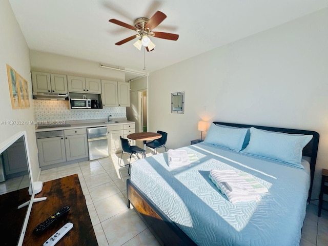 bedroom featuring ceiling fan, sink, and light tile patterned floors