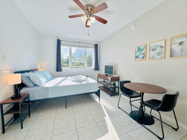 tiled bedroom featuring ceiling fan