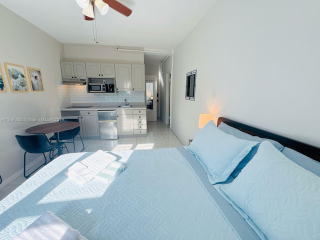 bedroom featuring light tile patterned floors, ceiling fan, and sink