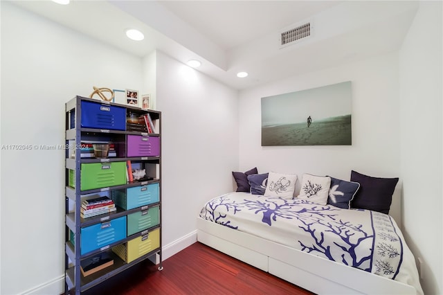 bedroom with dark hardwood / wood-style floors