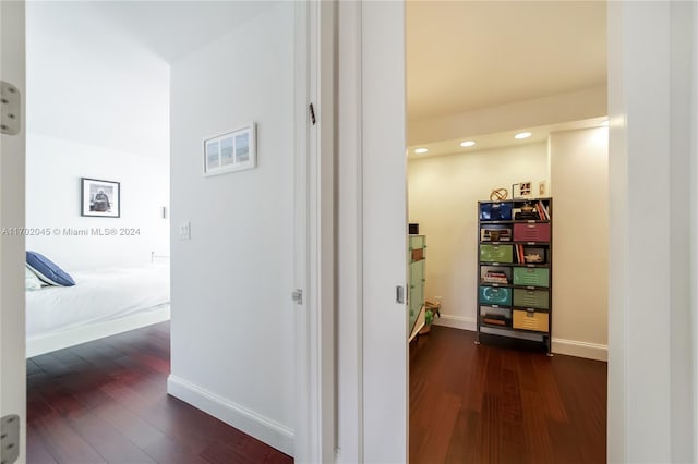 hallway with dark hardwood / wood-style flooring