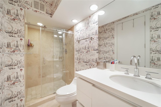 bathroom featuring walk in shower, vanity, and toilet