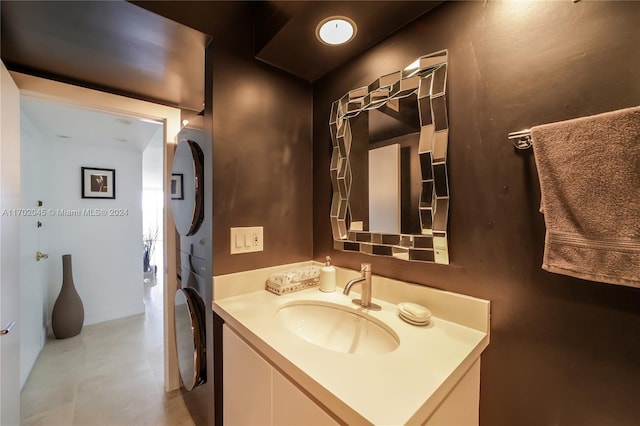 bathroom with vanity and stacked washer and clothes dryer