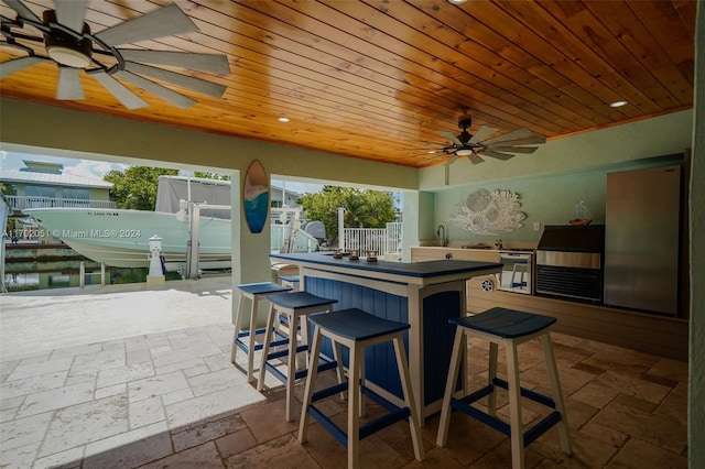 view of patio / terrace featuring a water view and an outdoor bar