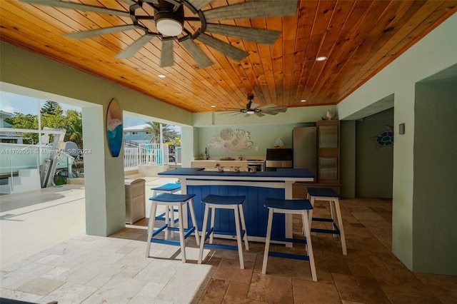 kitchen with a breakfast bar and wood ceiling