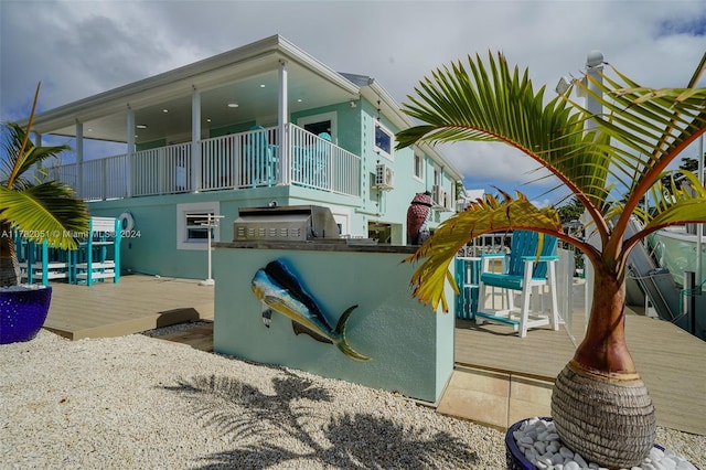 view of property exterior featuring exterior bar and a wooden deck