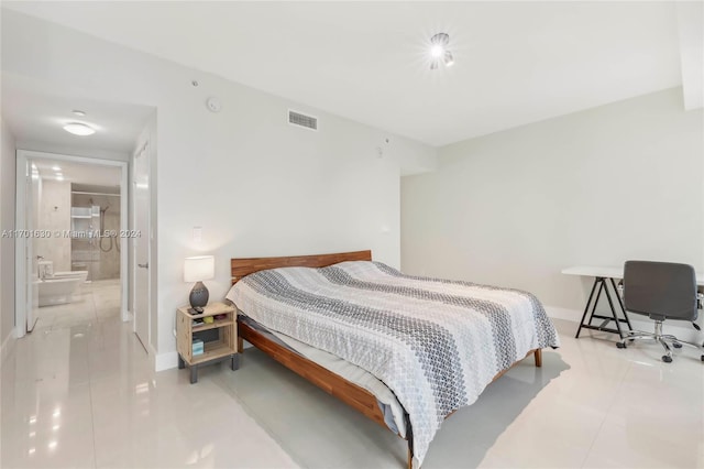 tiled bedroom featuring ensuite bathroom