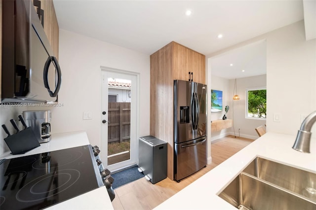 kitchen featuring light hardwood / wood-style floors, sink, and stainless steel appliances