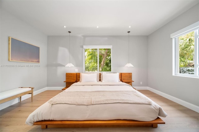 bedroom featuring light hardwood / wood-style floors and multiple windows