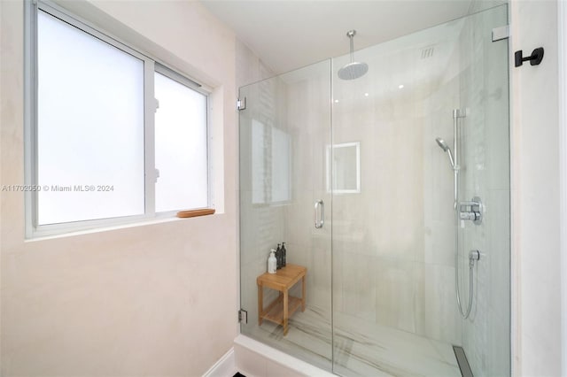 bathroom featuring a shower with door