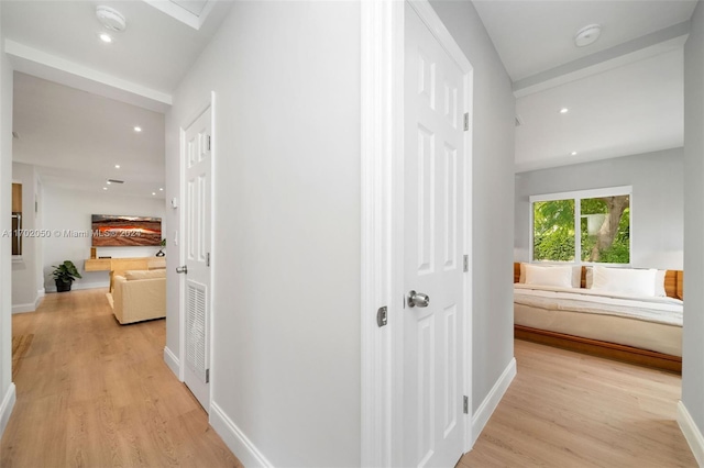 hallway with light hardwood / wood-style flooring