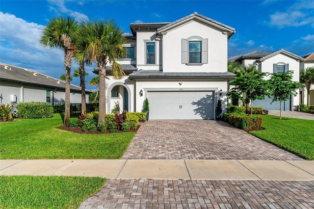 view of front facade with a garage and a front lawn