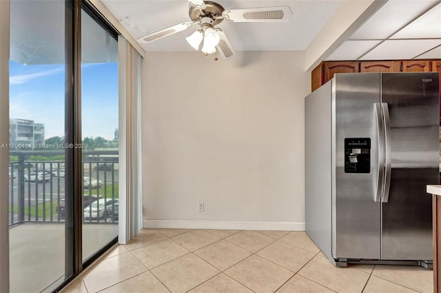 kitchen featuring ceiling fan, light tile patterned floors, and stainless steel refrigerator with ice dispenser