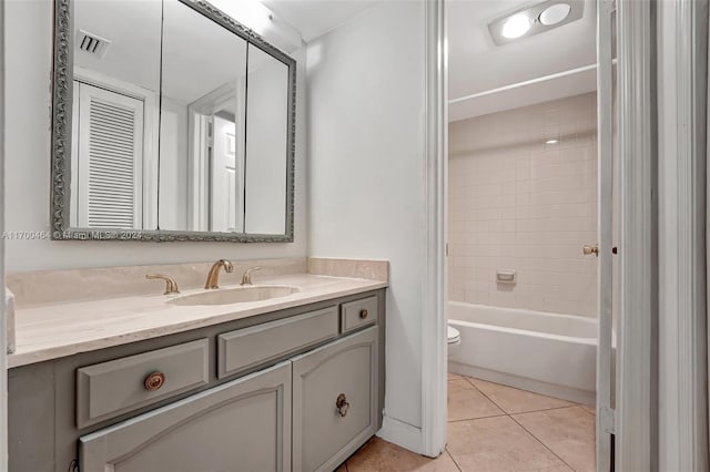 full bathroom featuring tile patterned flooring, vanity, toilet, and tiled shower / bath combo