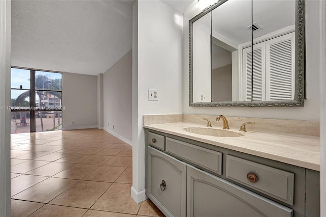 bathroom featuring tile patterned flooring, vanity, and a textured ceiling