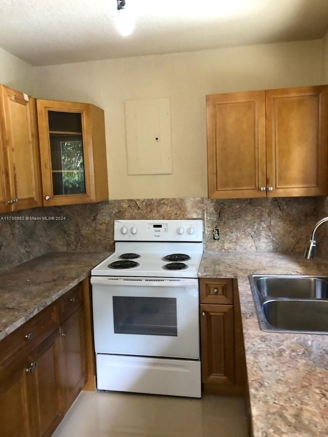 kitchen with white electric range, electric panel, tasteful backsplash, and sink