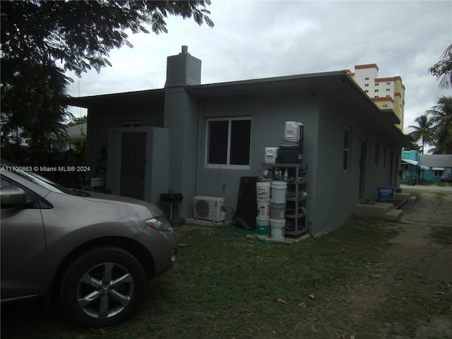 view of side of property featuring ac unit