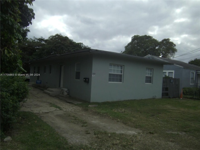 view of side of property with a lawn