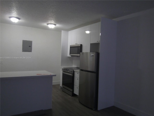 kitchen featuring dark hardwood / wood-style flooring, a textured ceiling, stainless steel appliances, electric panel, and white cabinetry