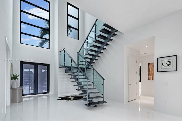 stairway featuring a high ceiling