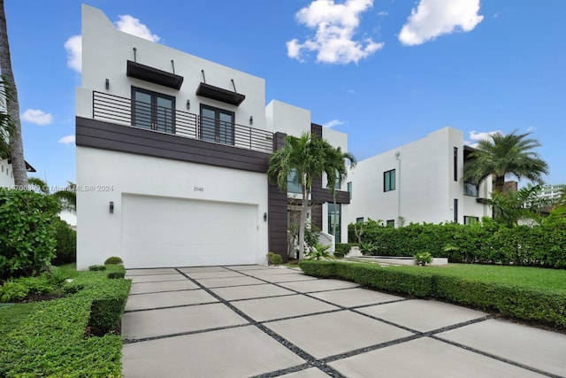 contemporary house with a balcony and a garage