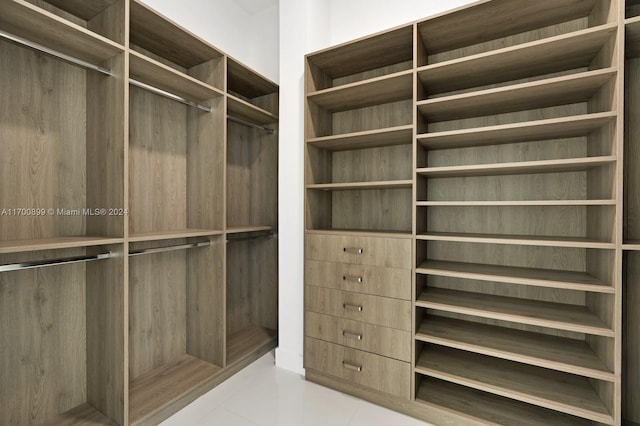 spacious closet with light tile patterned floors