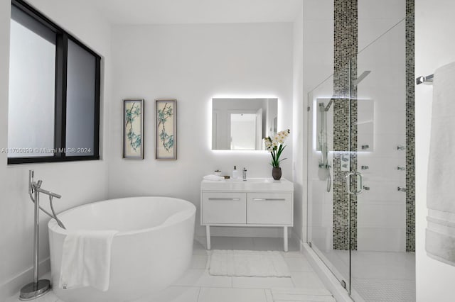 bathroom featuring vanity and independent shower and bath