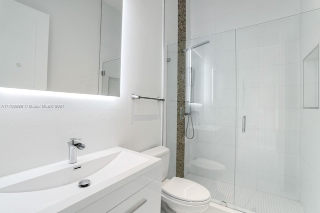 bathroom featuring vanity, toilet, and walk in shower