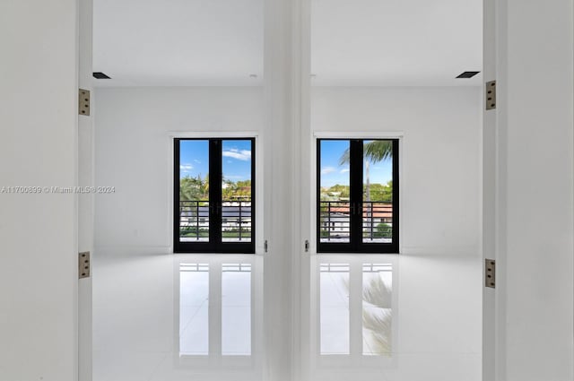 unfurnished room featuring french doors