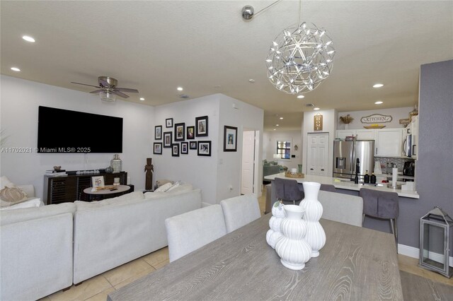 dining space featuring ceiling fan and light tile patterned floors