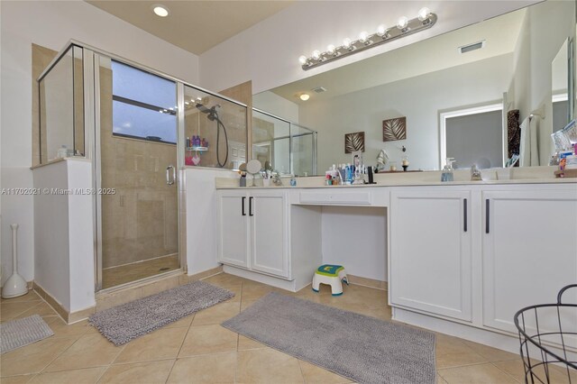 bathroom with tile patterned flooring, vanity, and a shower with shower door