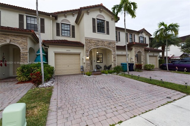 mediterranean / spanish-style home with a garage