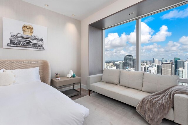 bedroom with light hardwood / wood-style flooring and multiple windows